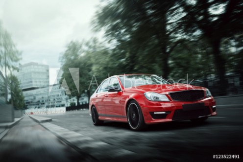 Picture of Red car drive on asphalt road in the city at daytime